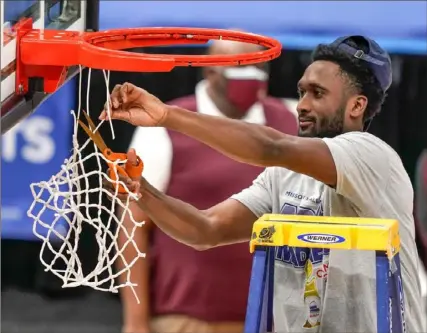  ?? Associated Press ?? Keith Clemons cuts down the net after Loyola of Chicago won the Missouri Valley Conference tournament. The Ramblers advance to the NCAA tournament for the first time since they reached the Final Four in 2018.