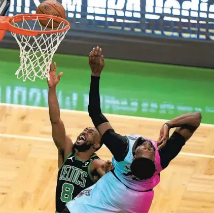  ?? STEVEN SENNE/AP ?? The Celtics’ Kemba Walker, left, shoots as the Heat’s Bam Adebayo defends during the first half on Sunday in Boston.