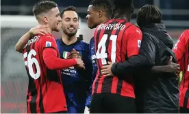  ?? Photograph: Matteo Bazzi/EPA ?? Inter goalscorer Hakan Calhanoglu speaks with his former Milan teammates after the draw at San Siro.