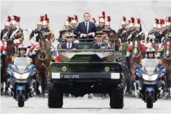  ?? — AFP ?? PARIS: Newly elected French president Emmanuel Macron parades in a military car on the Champs Elysees avenue after his formal inaugurati­on ceremony yesterday.