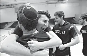  ?? AP Photo/Jessie Wardarski ?? Yeshiva forward Michael Bixon hugs forward Daniel Katz, back to camera, after the team's 102-83 win over Penn State-Harrisburg in the second round of the NCAA men's Division III college basketball tournament Saturday in Baltimore.