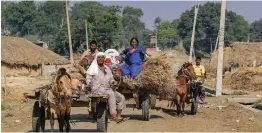  ?? — PTI ?? Villagers leave with their belongings for safer place after heavy shelling from the Pakistani side along the internatio­nal border at Jora farm village of R. S. Pura near Jammu on Thursday.