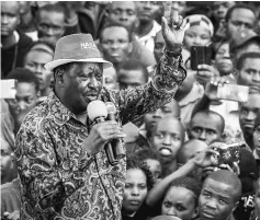  ??  ?? Kenya’s opposition leader Raila Odinga (left) of the opposition National Super Alliance (NASA) coalition, speaks to supporters as he arrives on a car to a political rally in Machakos, 60km east of Nairobi. — AFP photo