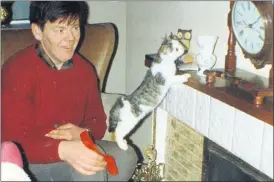  ?? ?? Pictured 50 years ago, Michael Sheehan, from Mitchelsto­wn, putting the clock back on the fireplace mantle - with the assistance of the family pet - having put the clock forward for another year. This Sunday morning, March 31st at 1am, the time will go forward by 1 hour - don’t forget to reset your clocks!