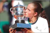  ??  ?? Latvia’s Jelena Ostapenko kisses the trophy after winning the French Open title with a 4-6, 6-4, 6-3 victory over Romania’s Simona Halep on Saturday at the Roland Garros Stadium in Paris.