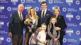  ?? Adam Hunger Associated Press ?? ARCHIE MANNING, far left, and his wife, Olivia, far right, pose with son Eli and his family after Eli announced his retirement from the NFL in January.