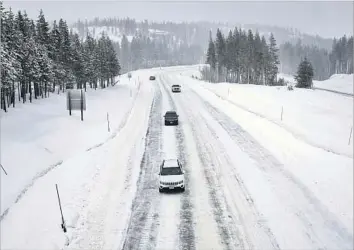  ?? Gary Coronado Los Angeles Times ?? TRAFFIC is light on snowy Interstate 80 in Soda Springs, Calif. The next round of storms will be colder, meaning more of the snow will stick around. That’s good news for the state’s water collection systems.