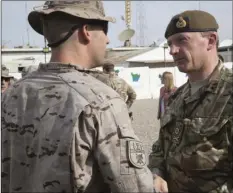  ??  ?? In this 2018 photo, British army Maj. Gen. Christophe­r Ghika, deputy commander for Strategy and Informatio­n, Combined Joint Task Force - Operation Inherent Resolve (CJTF-OIR), shakes hands with a Spanish soldier during a transfer of authority ceremony at the Besmaya Range Complex, Iraq.
SPC. ERIC CERAMI/U.S. ARMY VIA AP