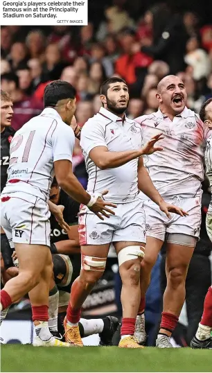  ?? IMAGES ?? Georgia’s players celebrate their famous win at the Principali­ty Stadium on Saturday.getty