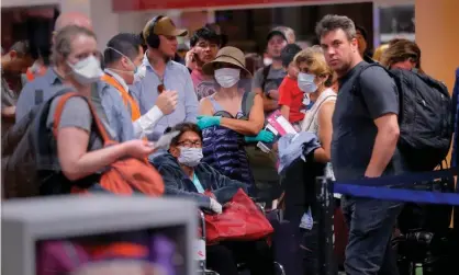  ??  ?? Travellers await flights out of Peru last week. Photograph: Luka Gonzales/AFP via Getty Images