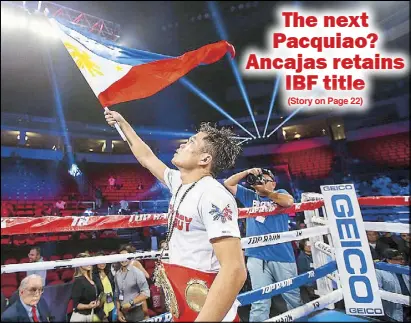  ?? PHOTO COURTESY OF TOP RANK ?? Jerwin Ancajas waves the Philippine flag after his victory by unanimous decision over fellow Filipino Jonas Sultan to retain the IBF super flyweight crown in their 12-round title bout Saturday night in Fresno, California.