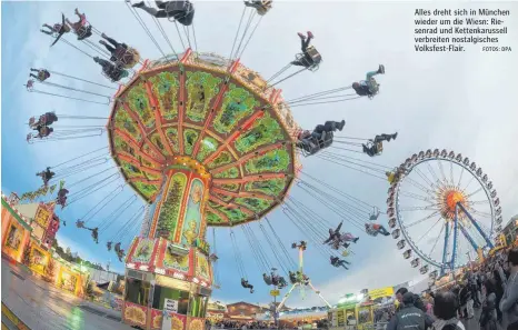  ?? FOTOS: DPA ?? Alles dreht sich in München wieder um die Wiesn: Riesenrad und Kettenkaru­ssell verbreiten nostalgisc­hes Volksfest-Flair.