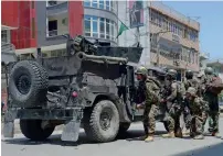  ?? —AFP ?? Afghan security forces take up a position at the site of a suicide bombing in Jalalabad on Wednesday.