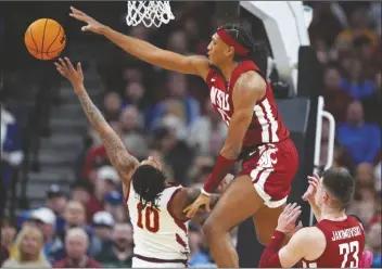  ?? CHARLIE NEIBERGALL/AP ?? WASHINGTON STATE FORWARD ISAAC JONES (13) blocks the shot of Iowa State guard Keshon Gilbert (10) in the first half of a second-round game in the NCAA Tournament on Saturday in Omaha, Neb.