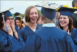  ?? DANA JENSEN THE DAY ?? From left to right, Faith Coombe, Anna Lindh and Allison Antcliff share a laugh with Carter Smith, back to camera, as they and their fellow graduates gather before the Ledyard High School graduation ceremony on Friday. Go to theday.com to view a photo...