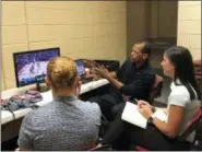  ?? TIM REYNOLDS — THE ASSOCIATED PRESS ?? NBA referee Eric Lewis breaks down a play with referees Ashley Gilpin, left, and Natalie Sago, right, after a Summer League game in Las Vegas on July 16.