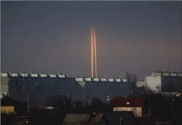  ?? VADIM BELIKOV — THE ASSOCIATED PRESS ?? Three Russian rockets launched against Ukraine from Russia’s Belgorod region are seen at dawn Thursday in Kharkiv, Ukraine.