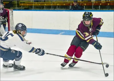  ?? TIM MARTIN/THE DAY ?? The Eagles’ Evan Tower, right, skates past Robert Wehmhoff of Staples during Thursday night’s CIAC Division III hockey semifinal at Yale’s Ingalls Rink in New Haven. Tower and the Eagles will face rival Tri-Town for the state title at 10 a.m. today,...