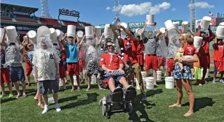  ?? BOSTON HERALD FILE ?? HELPING OTHERS: On July 31, 2015, Red Sox players, staff, Pete Frates, his wife and daughter participat­e in the Ice Bucket Challenge. Nancy Frates, below, checks on Pete after he was presented with the NCAA Inspiratio­n award in his Beverly home in 2016.