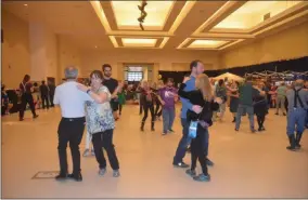  ?? LAUREN HALLIGAN - MEDIANEWS GROUP ?? Participan­ts dance with partners during a session at the 33rd annual Flurry Festival on Sunday in Saratoga Springs.