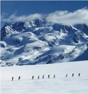  ??  ?? From top: Trekkers crossing the Theodul Glacier, with Monte Rosa in the background; a traditiona­l Valais platter featuring paper-thin slices of air-dried beef and cured ham.