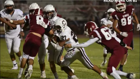  ?? PHOTO AARON BODUS ?? Calexico junior Chris Gonzalez (27) attempts to elude a defender during Friday’s game against Kofa high school in yuma. the Bulldogs won the game, 39-6.