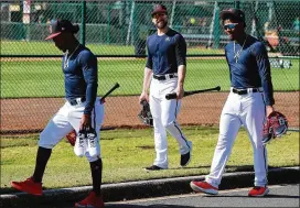  ?? CURTIS COMPTON / CCOMPTON@AJC.COM ?? Ozzie Albies (from left), Ender Inciarte and Ronald Acuna Jr. head to practice Sunday at the ESPN Wide World of Sports Complex.