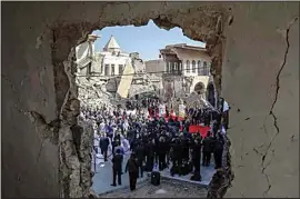  ?? ANDREW MEDICHINI / AP ?? Pope Francis, surrounded by shells of destroyed churches, attends a prayer Sunday for the victims of war at Hosh al-Bieaa Church Square, in Mosul, Iraq, once the de-facto capital of IS.