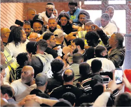  ??  ?? > Protesters storm Kensington Town Hall yesterday as 30 people were confirmed dead with more than 70 still missing