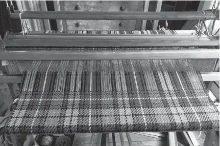  ?? CONTRIBUTE­D ?? The family tartan Amber Buchanan is weaving on her loom.