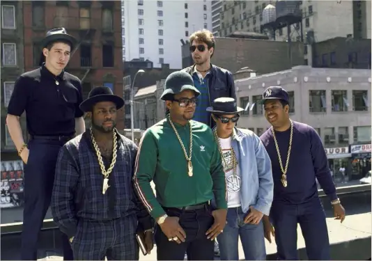  ??  ?? Golden days: Run-DMC and the Beastie Boys coordinate their dookie chain game, 1987