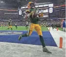  ?? MARK HOFFMAN/MILWAUKEE JOURNAL SENTINEL ?? Green Bay Packers running back Aaron Jones tosses the ball in the stands after scoring a touchdown against the Dallas Cowboys.