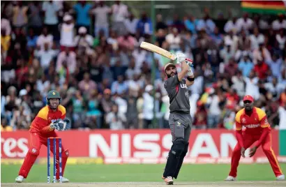  ?? AP ?? Rameez Shahzad plays a shot during his innings of 59 from 61 balls to help UAE post 235 and then restrict Zimbabwe to 226. —