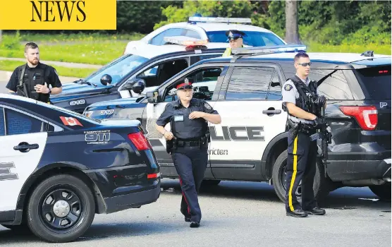  ?? KEITH MINCHIN / THE CANADIAN PRESS ?? Police respond to the scene in Fredericto­n, N.B., on Friday, where officers Robb Costello and Sara Burns were killed. The accused gunman is in hospital.