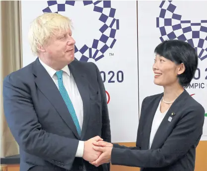  ??  ?? Britain’s Foreign Secretary Boris Johnson, left, and Japan’s Olympic Minister Tamayo Marukawa shake hands.