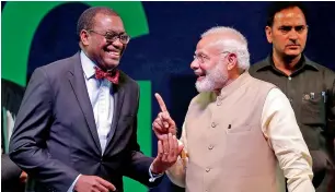  ?? — Reuters ?? Narendra Modi shares a light moment with AfDB president Akinwumi Adesina at the inaugurati­on ceremony of the annual general meeting of the bank in Gandhinaga­r on Tuesday.