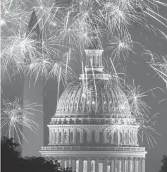  ??  ?? Fireworks explode over the National Mall as the US Capitol (right) and National Monument are seen in Washington, DC. — AFP photo