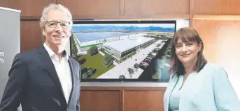  ??  ?? FACTORY CHARGE: Mayor Jenny Hill with former managing director of Magnis Energy Technologi­es Marc Vogts in front of an artist's impression of the new battery plant last year.