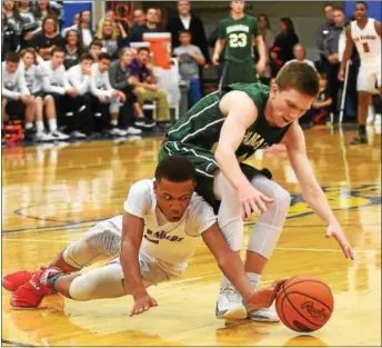  ?? PETE BANNAN — DIGITAL FIRST MEDIA ?? Coatesvill­e’s Jahmir Brickus and Bishop Shanahan’s Joe O’Malley dive for the basket in overtime as the Red Raiders beat Shanahan, 43-37, to win the Ches-Mont title at Downingtow­n West Thursday night.