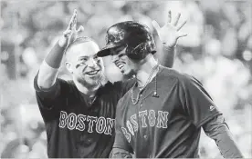  ?? SEAN M. HAFFEY
GETTY IMAGES ?? Mookie Betts of the Boston Red Sox is congratula­ted by his teammate Christian Vazquez after his sixth inning home run against the Dodgers in Game Five of the 2018 World Series.