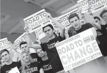  ?? Miami Herald ?? Students stage a “March for Our Lives” after the gun massacre at Marjory Stoneman Douglas High School in 2018.