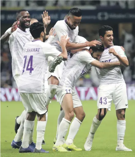  ?? Reuters ?? Bandar Al Ahbabi, right, and his Al Ain teammates celebrate victory at the Hazza bin Zayed Stadium