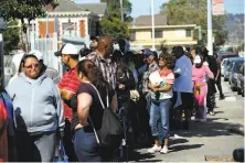  ?? Michael Short / Special to the Chronicle 2012 ?? Residents stand in line outside the Nevins Community Complex in Richmond in order to file claims against Chevron.