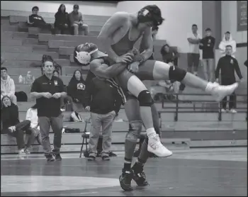  ?? MEGAN WIDICK/Special to the Valley Press ?? THROW DOWN — Highland wrestler Andrew Shamburger picks up Littlerock’s Arnold Topete during the match at 145 pounds at Highland on Wednesday. Shamburger won the match 9-7 in overtime. Littlerock won the overall team match to stay undefeated in the Golden League.