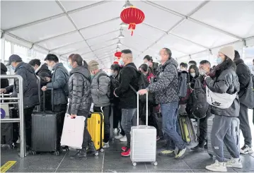  ?? REUTERS ?? People queue at a railway station in Shanghai during the annual Spring Festival travel rush ahead of the Chinese Lunar New Year, amid a Covid-19 outbreak yesterday.