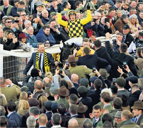  ??  ?? Jockey Paul Townend celebrates on Al Boum Photo after winning the Cheltenham Gold Cup, a race that will be one of the last sporting events to take place for weeks