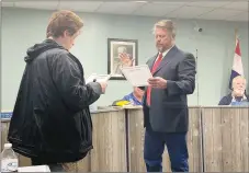  ?? SALLY CARROLL/MCDONALD COUNTY PRESS ?? JR Fisher reads his oath during his swearing-in ceremony as Goodman Mayor on Monday night. City clerk Karla McNorton helped with the ceremony after Goodman City Council members voted to have Fisher fill the remainder of Greg Richmond’s term. Richmond resigned as mayor on Jan. 6, effective immediatel­y.