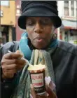  ?? Nate Guidry/Post-Gazette ?? Shawna Bridgett of the Hill District gets a free ice custard from Rita's Italian Ice on East Ohio Street last year.