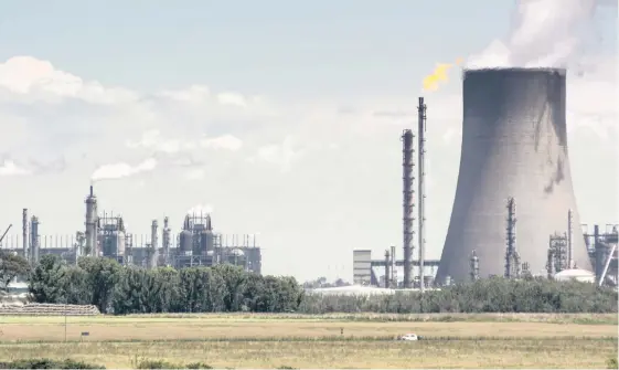  ?? | WALDO SWIEGERS Bloomberg ?? VAPOUR rises from the cooling tower of the Sasol Secunda coal-to-liquids plant in Mpumalanga. At 56.5 million tons of greenhouse gases a year, Secunda’s emissions exceed the individual totals of more than 100 countries, including Norway and Portugal, according to the Global Carbon Atlas.