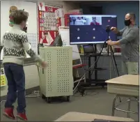  ?? IMAGE FROM SCREENSHOT ?? North Penn School District uses its 50-inch screens to conduct physical education classes in the classroom and at home.